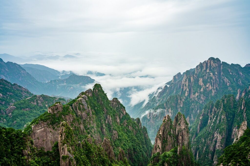 a mountain range with trees and clouds mount huangshan map