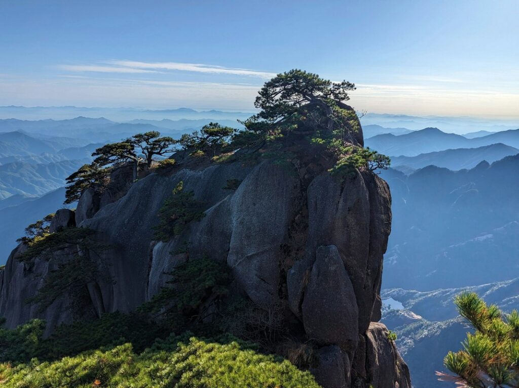 a rocky mountain with trees on top yellow mountain anhui china