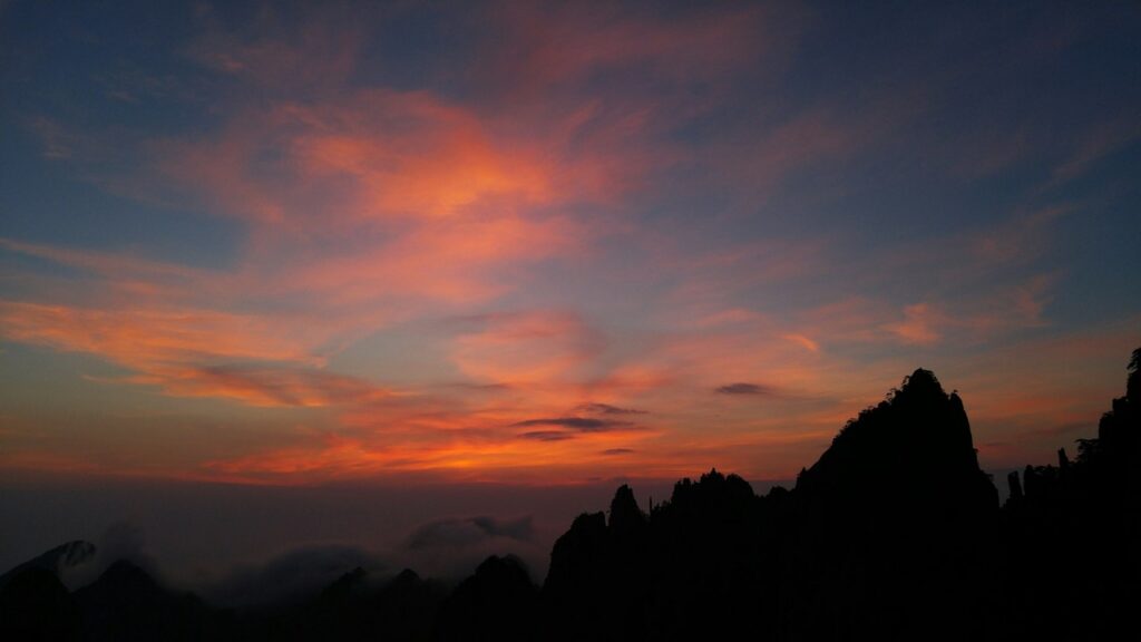 a sunset over a mountain yellow mountain anhui china