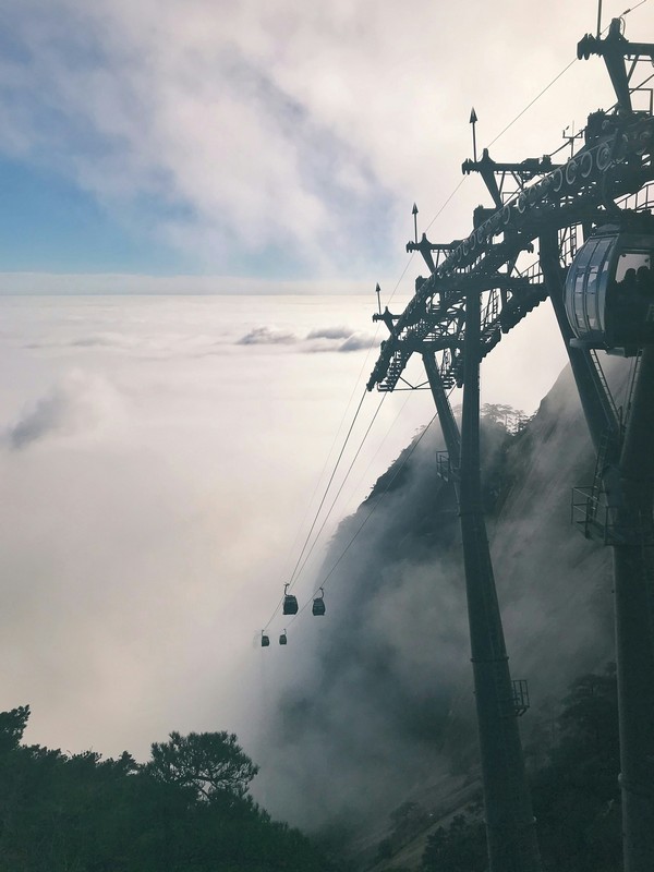 a cable car going up to the top of a mountain yellow mountain china