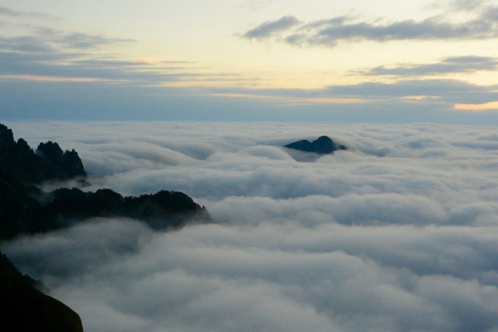 clouds above a mountain yellow mountain hike china